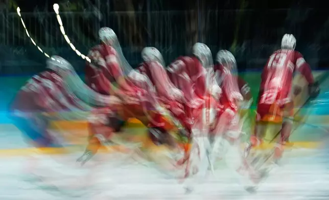 Switzerland players warm up for a men's ice hockey qualification playoff game between Switzerland and Italy at the 2026 Winter Olympics, in Milan, Italy, Tuesday, Feb. 17, 2026. (AP Photo/Petr David Josek)