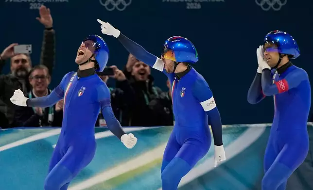 Team Italy with Michele Malfatti, left, Davide Ghiotto, center, and Andrea Giovannini, right, celebrate winning the gold medal in the final of the men's team pursuit speedskating race at the 2026 Winter Olympics, in Milan, Italy, Tuesday, Feb. 17, 2026. (AP Photo/Ben Curtis)