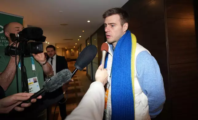 Ukrainian skeleton athlete Vladyslav Heraskevych speaks to the media as he arrives for a CAS appeal hearing in Milan, Italy, Friday, Feb. 13, 2026. (AP Photo/Antonio Calanni)