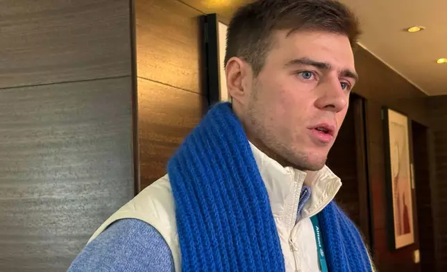 Ukrainian skeleton athlete Vladyslav Heraskevych speaks to the media amid an ongoing appeal hearing in Milan, Italy, Friday, Feb. 13, 2026. (AP Photo/Stefanie Dazio)