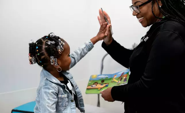 Juri Sleet, 4, works with Crystal Webb, a kindergarten readiness coordinator at Linden Primary Care Center at Nationwide Children's Hospital, Thursday, Dec. 11, 2025, in Columbus, Ohio. (AP Photo/Jessica Phelps)