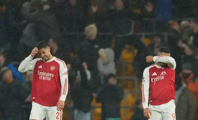 Arsenal's Gabriel Jesus and William Saliba react during the Premier League soccer match between Wolverhampton Wanderers and Arsenal in Wolverhampton, England, Wednesday, Feb. 18, 2026. (AP Photo/Dave Shopland)