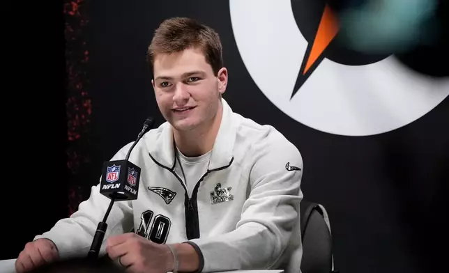 New England Patriots quarterback Drake Maye laughs during the NFL Super Bowl Opening Night, Monday, Feb. 2, 2026, in San Jose, Calif. ahead of the Super Bowl 60 football game between the New England Patriots and the Seattle Seahawks. (AP Photo/Brynn Anderson)