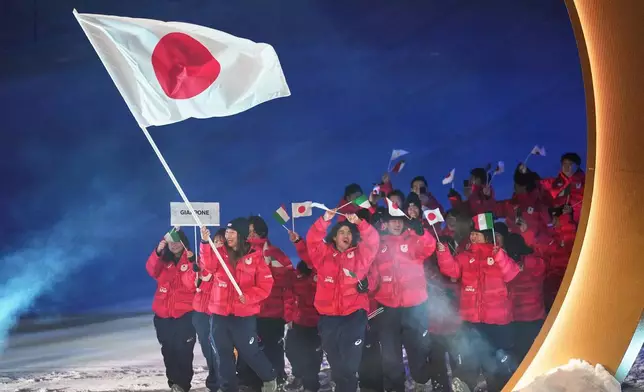 Sena Tomita, flag bearer of Japan, walks with athletes during the Olympic opening ceremony at the 2026 Winter Olympics, in Livigno, Italy, Friday, Feb. 6, 2026. (AP Photo/Abbie Parr)