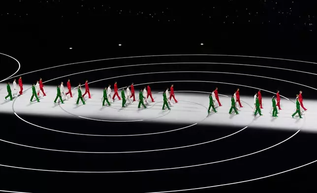 Artists wearing Italian colors perform during the Olympic opening ceremony at the 2026 Winter Olympics, in Milan, Italy, Friday, Feb. 6, 2026. (AP Photo/Petr David Josek)