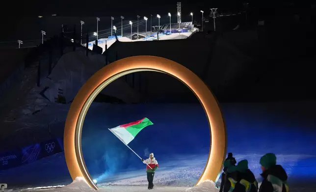 Mathieu Gravier, flag bearer of Madagascar, walks during the Olympic opening ceremony at the 2026 Winter Olympics, in Livigno, Italy, Friday, Feb. 6, 2026. (AP Photo/Abbie Parr)