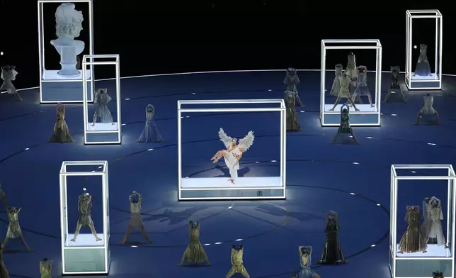 Performers take part in the Olympic opening ceremony at the 2026 Winter Olympics, in Milan, Italy, Friday, Feb. 6, 2026. (AP Photo/Ben Curtis)