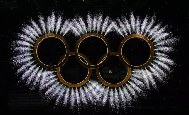 Fireworks explode around the Olympic rings during the Olympic opening ceremony at the 2026 Winter Olympics, in Milan, Italy, Friday, Feb. 6, 2026. (AP Photo/Ben Curtis)
