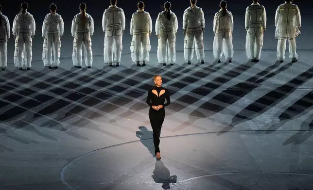 Actress Charlize Theron performs during the Olympic opening ceremony at the 2026 Winter Olympics, in Milan, Italy, Friday, Feb. 6, 2026. (AP Photo/Hassan Ammar)