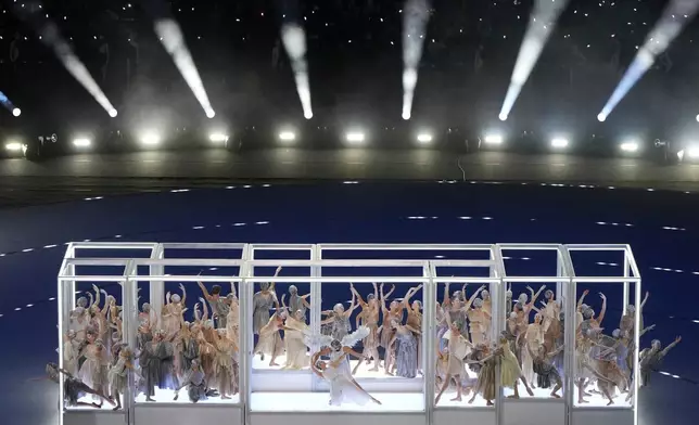 Dancers perform during the Olympic opening ceremony at the 2026 Winter Olympics, in Milan, Italy, Friday, Feb. 6, 2026. (AP Photo/Francisco Seco)