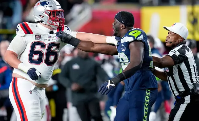 New England Patriots tackle Will Campbell (66) and Seattle Seahawks linebacker Derick Hall exchange words during the second half of the NFL Super Bowl 60 football game, Sunday, Feb. 8, 2026, in Santa Clara, Calif. (AP Photo/Sue Ogrocki)