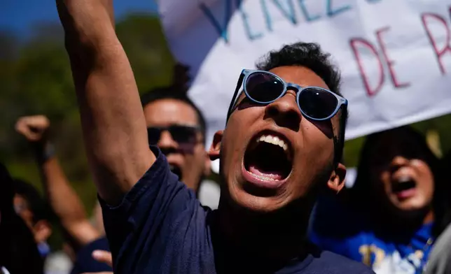 People attend a student-led march on National Youth Day to call for the release of detainees, considered to be political prisoners by their relatives and human rights groups, in Caracas, Venezuela, Thursday, Feb. 12, 2026. (AP Photo/Ariana Cubillos)
