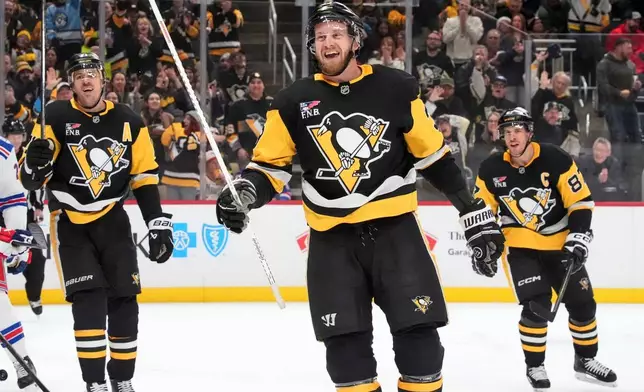 Pittsburgh Penguins' Anthony Mantha, center, celebrates in the second period with Evgeni Malkin, left, and Sidney Crosby, right, after his second goal of an NHL hockey game against the New York Rangers in Pittsburgh, Saturday, Jan. 31, 2026. (AP Photo/Gene J. Puskar)