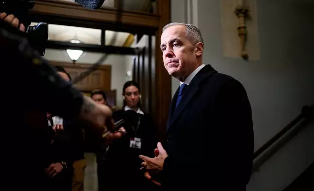 Prime Minister Mark Carney speaks to reporters ahead of a caucus meeting on Parliament Hill in Ottawa, on Wednesday, Feb. 11, 2026. (Spencer Colby /The Canadian Press via AP)