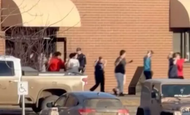 This grab from video shows students exiting the Tumbler Ridge school after deadly shootings, in British Columbia, Canada, Tuesday Feb. 10, 2026. (Jordon Kosik via AP)