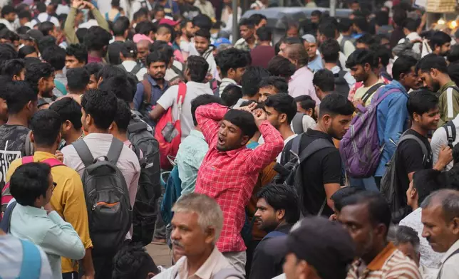 Indian daily wage laborers wait to get hired in Mumbai, India, Sunday, Feb. 1, 2026. (AP Photo/Rafiq Maqbool)