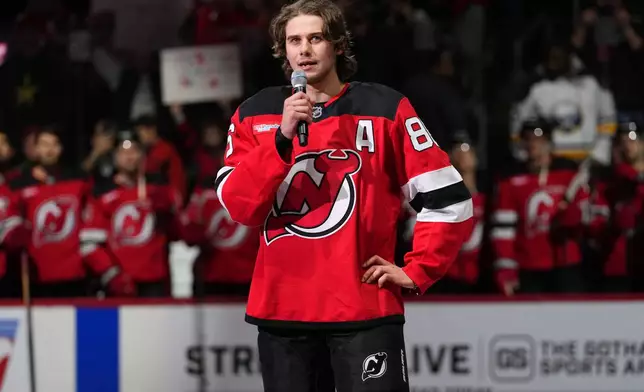 New Jersey Devils' Jack Hughes speaks to fans before an NHL hockey game against the Buffalo Sabres Wednesday, Feb. 25, 2026, in Newark, N.J. (AP Photo/Frank Franklin II)