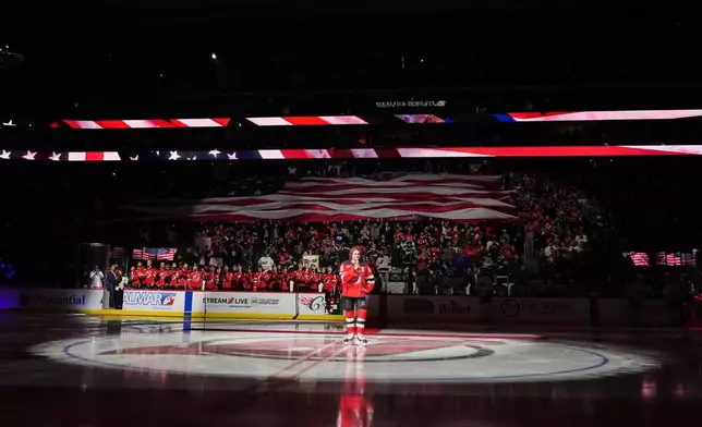 New Jersey Devils' Jack Hughes speaks to fans before an NHL hockey against the Buffalo Sabres Wednesday, Feb. 25, 2026, in Newark, N.J. (AP Photo/Frank Franklin II)