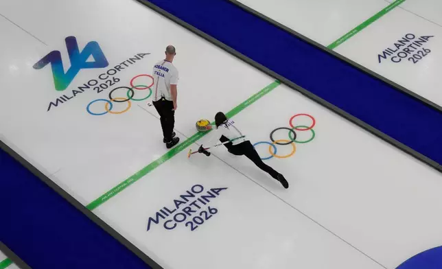 Italy's Stefania Constantini and Amos Mosaner compete during a curling mixed doubles round robin session against Sweden at the 2026 Winter Olympics, in Cortina d'Ampezzo, Italy, Saturday, Feb. 7, 2026. (AP Photo/David J. Phillip)