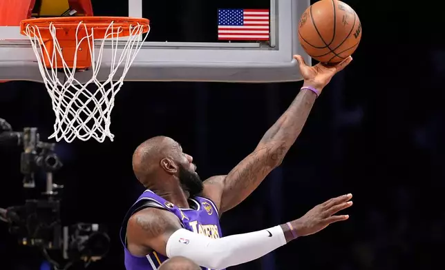Los Angeles Lakers forward LeBron James shoots during the first half of an NBA basketball game against the Dallas Mavericks, Thursday, Feb. 12, 2026, in Los Angeles. (AP Photo/Mark J. Terrill)