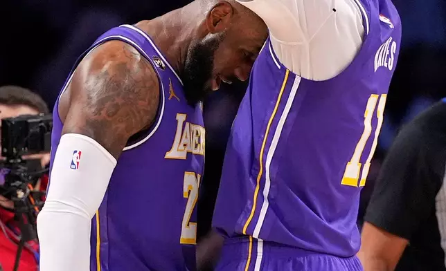 Los Angeles Lakers forward LeBron James, left, celebrates with center Jaxson Hayes after scoring during the first half of an NBA basketball game against the Dallas Mavericks, Thursday, Feb. 12, 2026, in Los Angeles. (AP Photo/Mark J. Terrill)