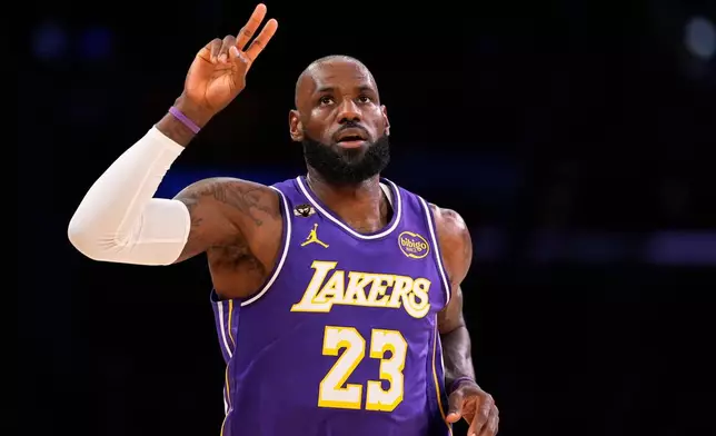 Los Angeles Lakers forward LeBron James gestures after scoring during the first half of an NBA basketball game against the Dallas Mavericks, Thursday, Feb. 12, 2026, in Los Angeles. (AP Photo/Mark J. Terrill)