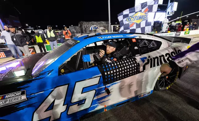 Tyler Reddick (45) reacts after winning a NASCAR Cup Series auto race, Sunday, Feb. 22, 2026, in Hampton, Ga. (AP Photo/Colin Hubbard)