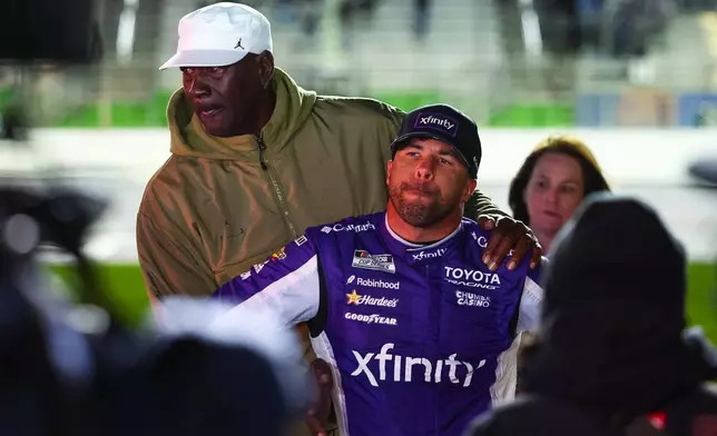 23XI Racing co-owner Michael Jordan, left, reacts with Bubba Wallace, right, after a NASCAR Cup Series auto race, Sunday, Feb. 22, 2026, in Hampton, Ga. (AP Photo/Colin Hubbard)