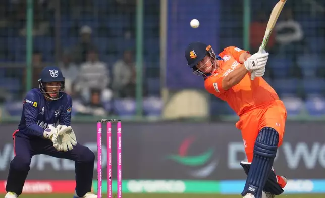 Netherlands' Michael Levitt hits a ball for four runs during the T20 World Cup cricket match between Namibia and Netherlands in New Delhi, India, Tuesday, Feb. 10, 2026. (AP Photo/Manish Swarup)