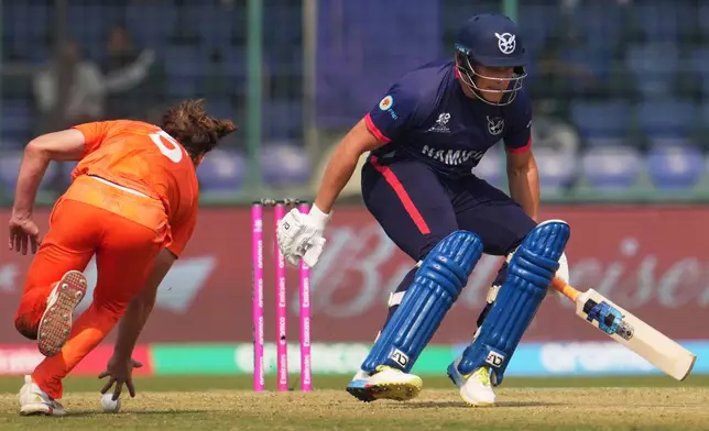 Netherlands' Bas de Leede, left, runs out Namibia's Ruben Trumpelmann during the T20 World Cup cricket match between Namibia and Netherlands in New Delhi, India, Tuesday, Feb. 10, 2026. (AP Photo/Manish Swarup)