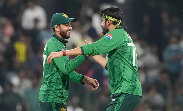Pakistan's Usman Tariq, right, and Pakistan's captain Salman Agha delegates after they won the T20 World Cup cricket match against the United States in Colombo, Sri Lanka, Tuesday, Feb. 10, 2026. (AP Photo/Eranga Jayawardena)