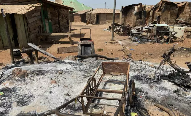 Burned homes and tools stand on an ash covered ground, days after an attack in the village of Woro, Nigeria, Thursday, Feb. 5, 2026. (AP Photo/Musa Salim)