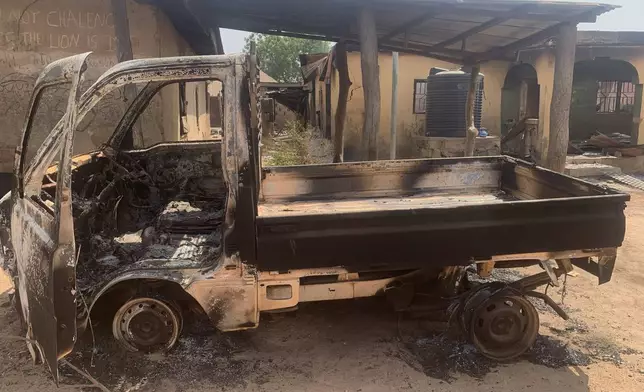 A burned truck and homes stand in ruins days after an attack in the village of Woro, Nigeria, Thursday, Feb. 5, 2026. (AP Photo/Musa Salim)