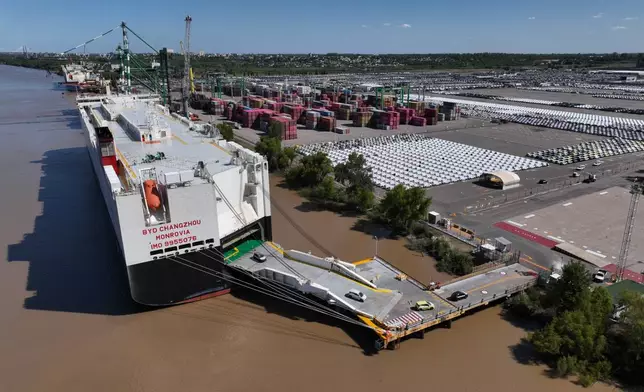 Hybrid and electric vehicles shipped from China are unloaded from the BYD Changzhou car carrier docked at Terminal Zarate, in Argentina's Buenos Aires province, Tuesday, Jan. 20, 2026. (AP Photo/Victor R. Caivano)