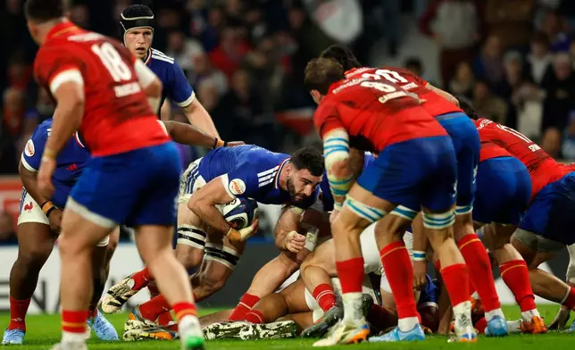 France's Charles Ollivon, center, hold s the ball during the Six Nations rugby union match between France and Italy in Lille, France, Sunday, Feb. 22, 2026. (AP Photo/Jean-Francois Badias)