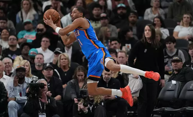 Oklahoma City Thunder guard Aaron Wiggins (21) saves the ball from going out of play during the first half of an NBA basketball game against the San Antonio Spurs in San Antonio, Wednesday, February. 4, 2026. (AP Photo/Eric Gay)