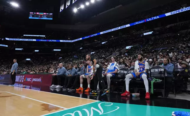 A limited roster of players watch from the bench during the second half of an NBA basketball game against the San Antonio Spurs in San Antonio, Wednesday, February. 4, 2026. (AP Photo/Eric Gay)