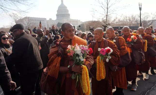 Buddhist monks walk near the U.S. Capitol, on Capitol Hill, during the Walk For Peace, Wednesday, Feb. 11, 2026, in Washington. (AP Photo/Rahmat Gul)
