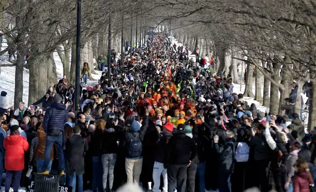 Buddhist monks walk on the National Mall near the Lincoln Memorial, during the Walk For Peace, Wednesday, Feb. 11, 2026, in Washington. (AP Photo/Rahmat Gul)