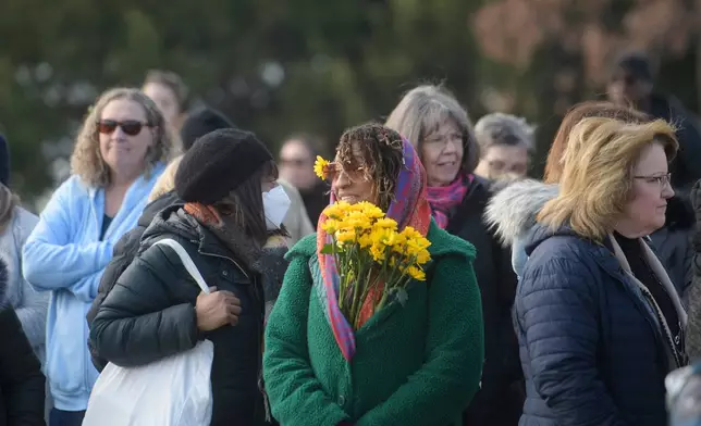 People wait for the arrival of the Buddhist monks near the Peace Monument on Capitol Hill, during the Walk for Peace, in Washington, Wednesday, Feb., 11, 2026. (AP Photo/Rod Lamkey, Jr.)