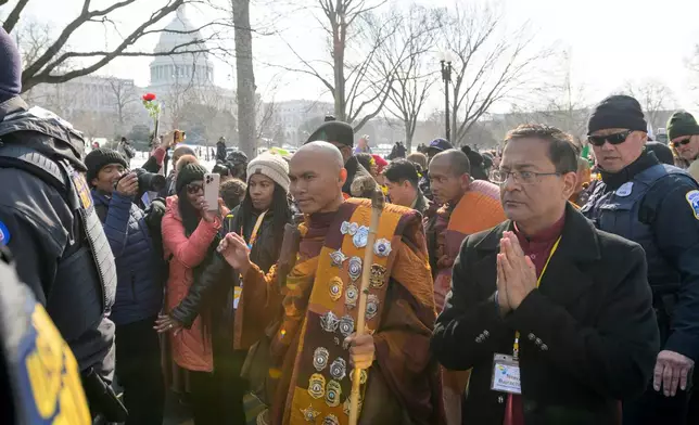With the Capitol in the background, Bhikkhu Pannakara, center, leads his fellow Buddhist monks near the Peace Monument on Capitol Hill, during the Walk for Peace, in Washington, Wednesday, Feb., 11, 2026. (AP Photo/Rod Lamkey, Jr.)