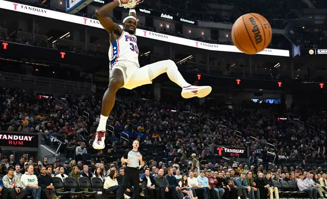 Philadelphia 76ers center Adem Bona dunks against the Golden State Warriors during the first half of an NBA basketball game Tuesday, Feb. 3, 2026, in San Francisco. (AP Photo/Eakin Howard)
