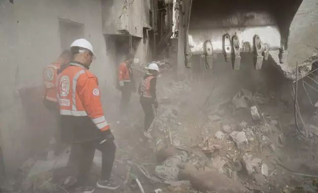Gaza's civil defense teams work to recover the remains of members of the Abu Nada family, who remain trapped beneath the rubble of their four-story house after it was destroyed by an Israeli airstrike in December 2023, in Gaza City, Monday, Feb. 9, 2026. (AP Photo/Jehad Alshrafi)