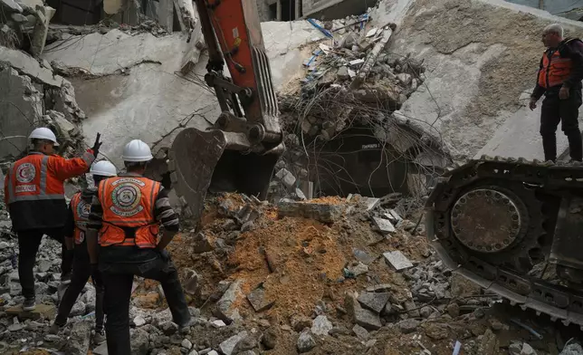 Gaza's civil defense teams work to recover the remains of members of the Abu Nada family, who remain trapped beneath the rubble of their four-story house after it was destroyed by an Israeli airstrike in December 2023, in Gaza City, Monday, Feb. 9, 2026. (AP Photo/Jehad Alshrafi)