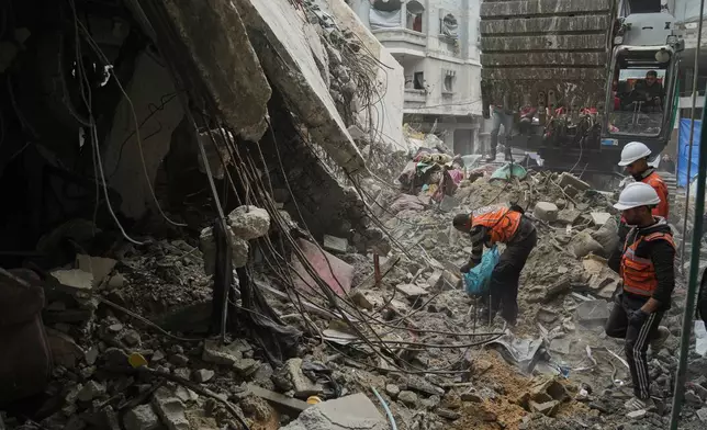 Gaza's civil defense teams work to recover the remains of members of the Abu Nada family, who remain trapped beneath the rubble of their four-story house after it was destroyed by an Israeli airstrike in December 2023, in Gaza City, Monday, Feb. 9, 2026. (AP Photo/Jehad Alshrafi)