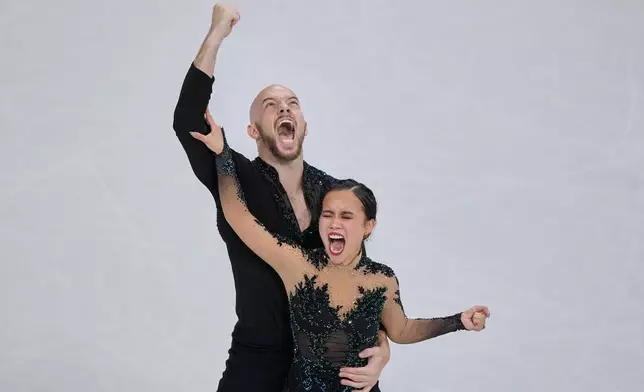 Ellie Kam and Danny O'Shea of the United States compete during the figure skating pairs team event at the 2026 Winter Olympics, in Milan, Italy, Sunday, Feb. 8, 2026. (AP Photo/Natacha Pisarenko)