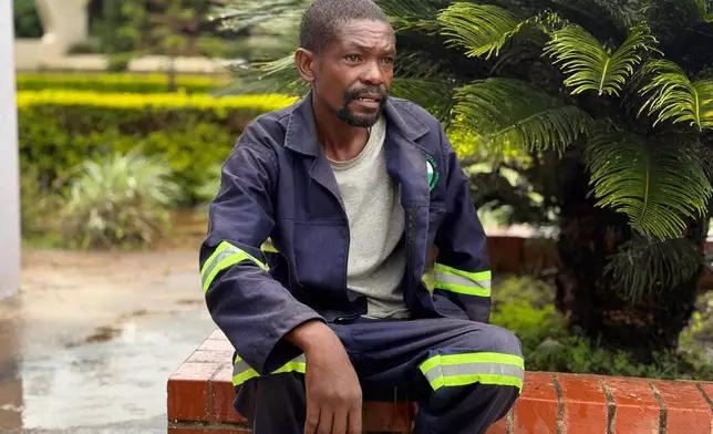 Allen Banda, cemetery caretaker, sits near the spot where authorities want to bury former president Edgar Lungu, in Lusaka, Zambia, Thursday, Feb.12, 2026. (AP Photo/Rodney Muhumuza)