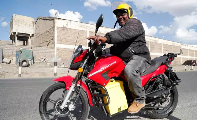 FILE -A man rides an electric motorcycle from Ampersand on a test drive in Nairobi, Kenya, Jan. 23, 2023. (AP Photo/Brian Inganga, File)