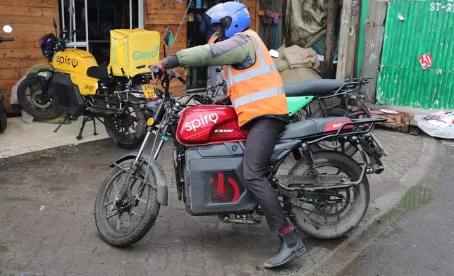 A rider sits on an electric Spiro motorcycle in Nairobi, Kenya, Tuesday, Feb. 24, 2026. (AP Photo/Henry Naminde)