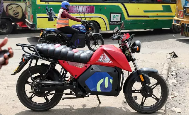 A man rides an electric Spiro motorcycle in Nairobi, Kenya, Tuesday, Feb. 24, 2026. (AP Photo/Henry Naminde)